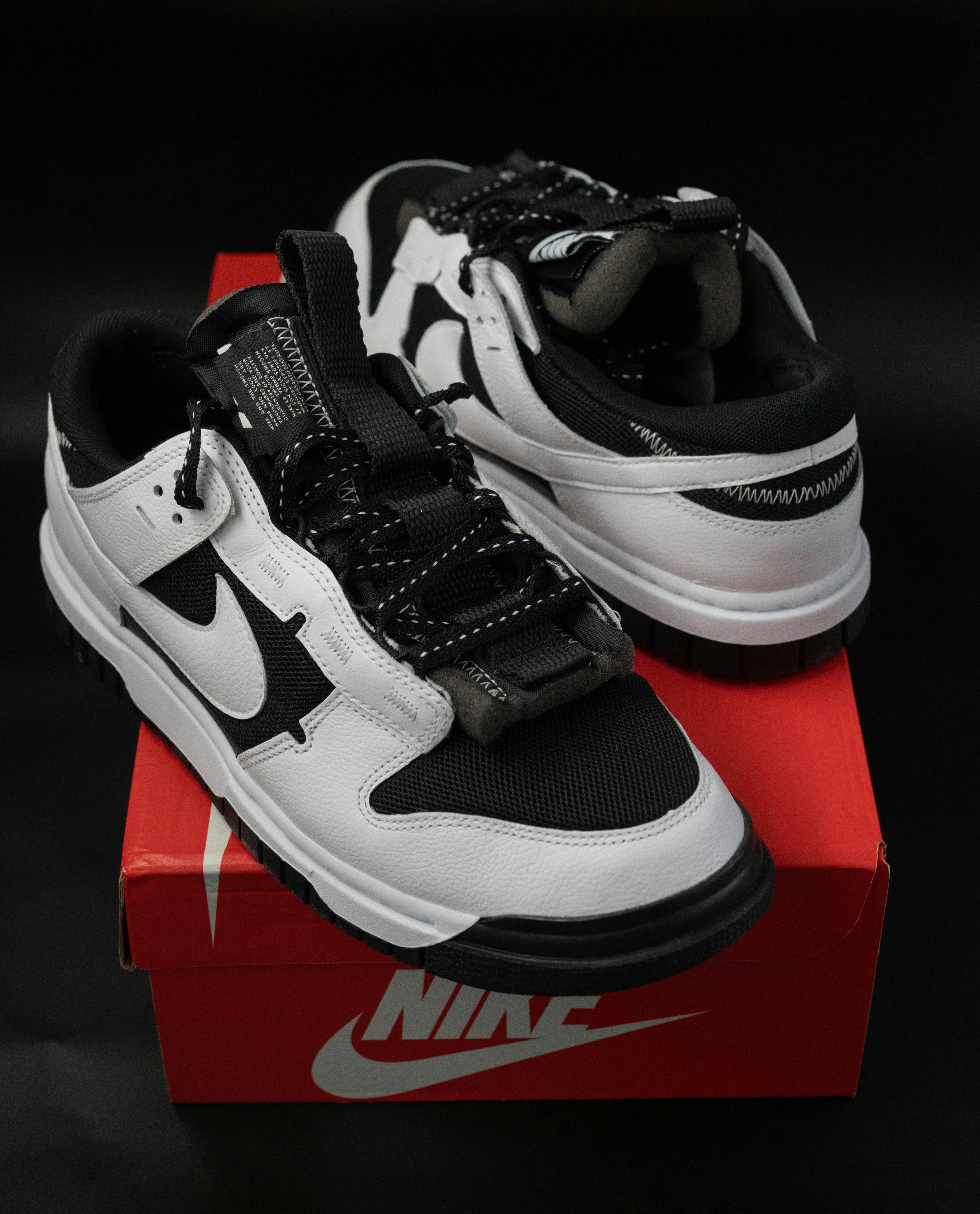 Red Nike sneakers on white surface, clean product photography