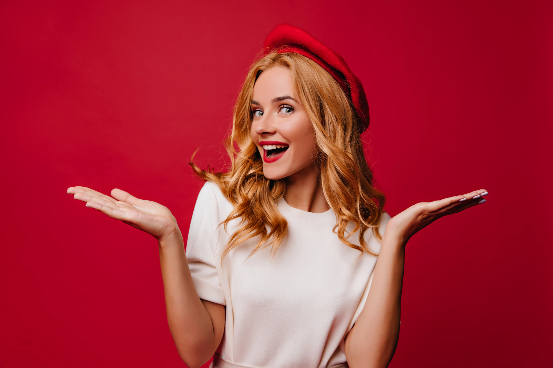 a woman in a white dress and a red hat