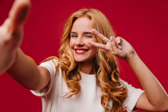 a woman making a hand sign with her fingers