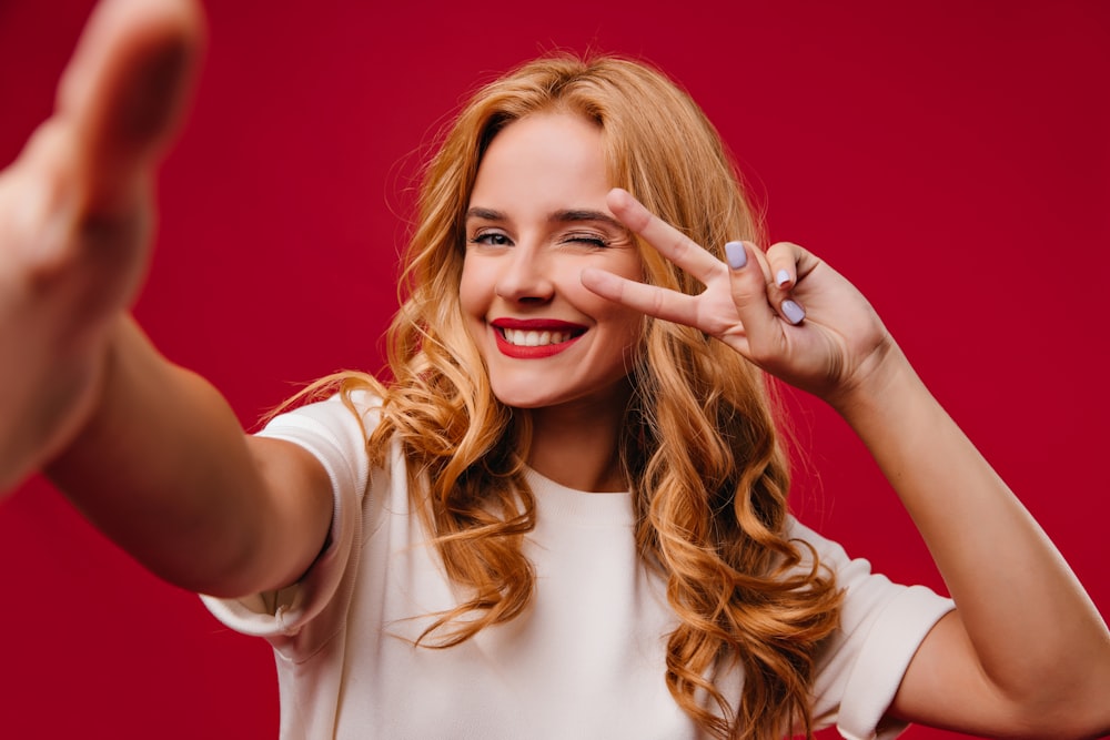 a woman making a hand sign with her fingers