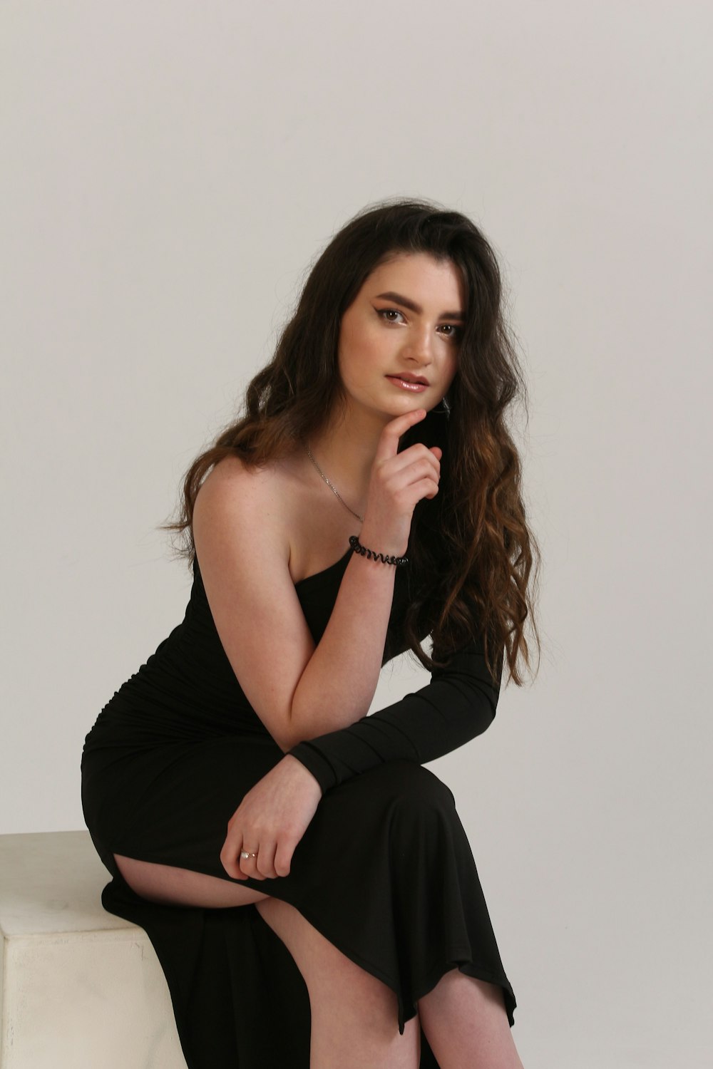 a woman in a black dress posing for a picture