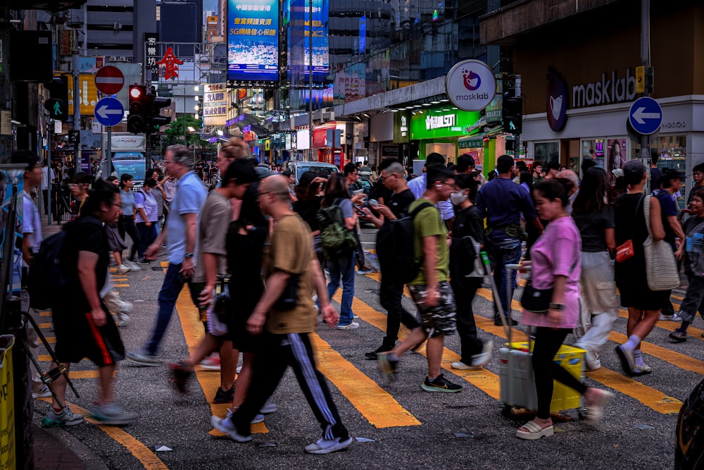 a crowd of people walking across a street