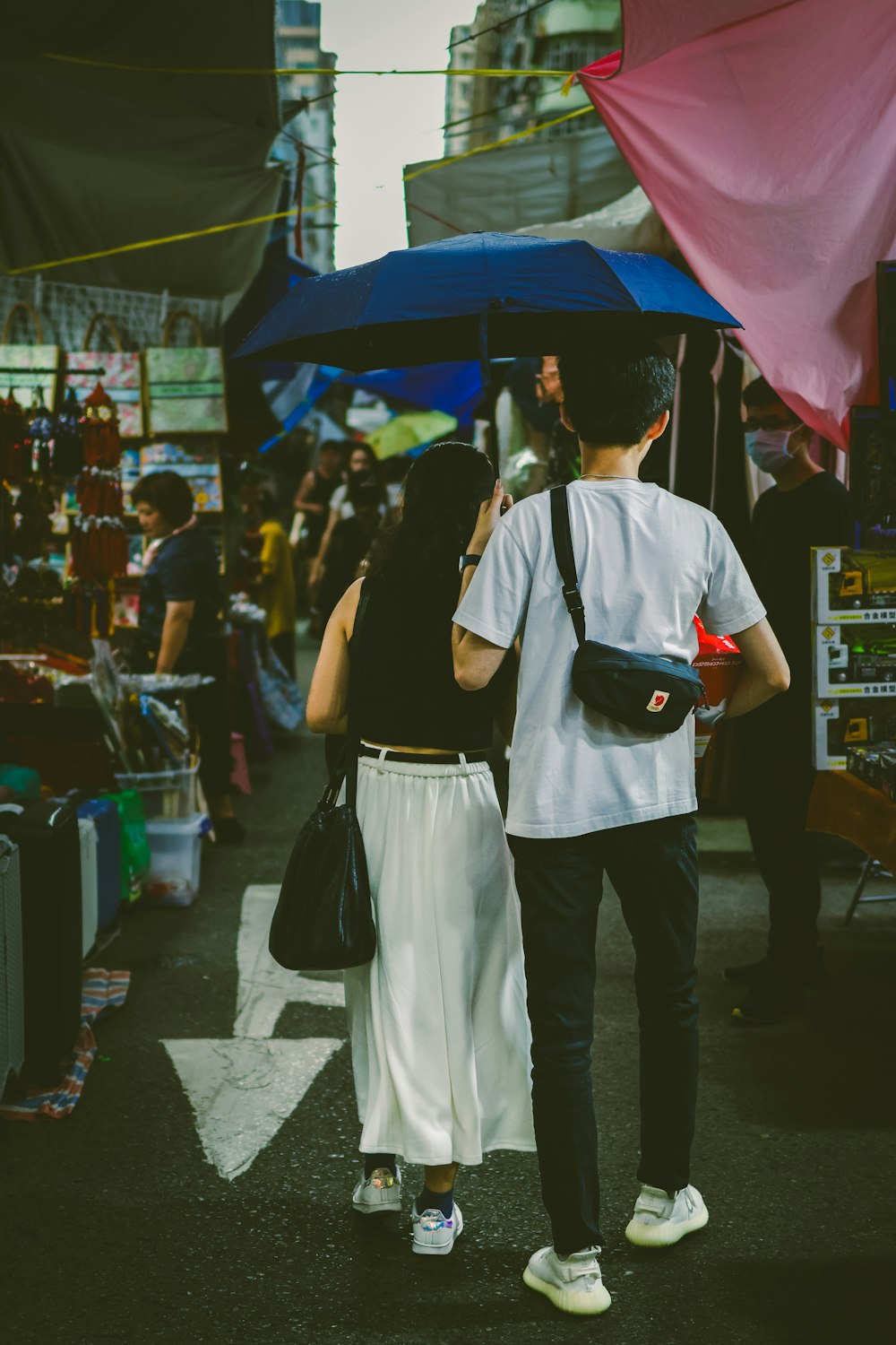 a man and a woman walking down a street