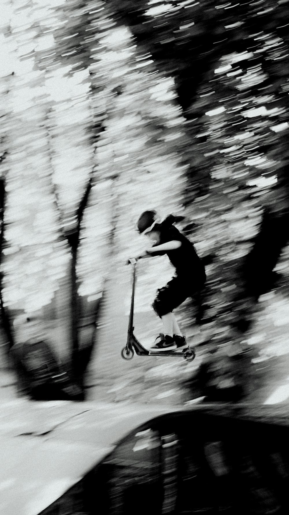 a man riding a scooter down a snow covered slope