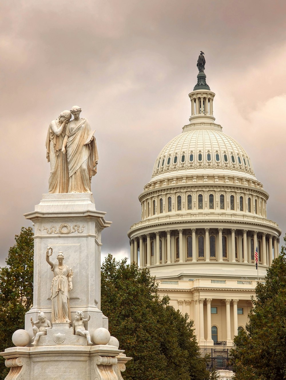 the capitol building with a statue in front of it