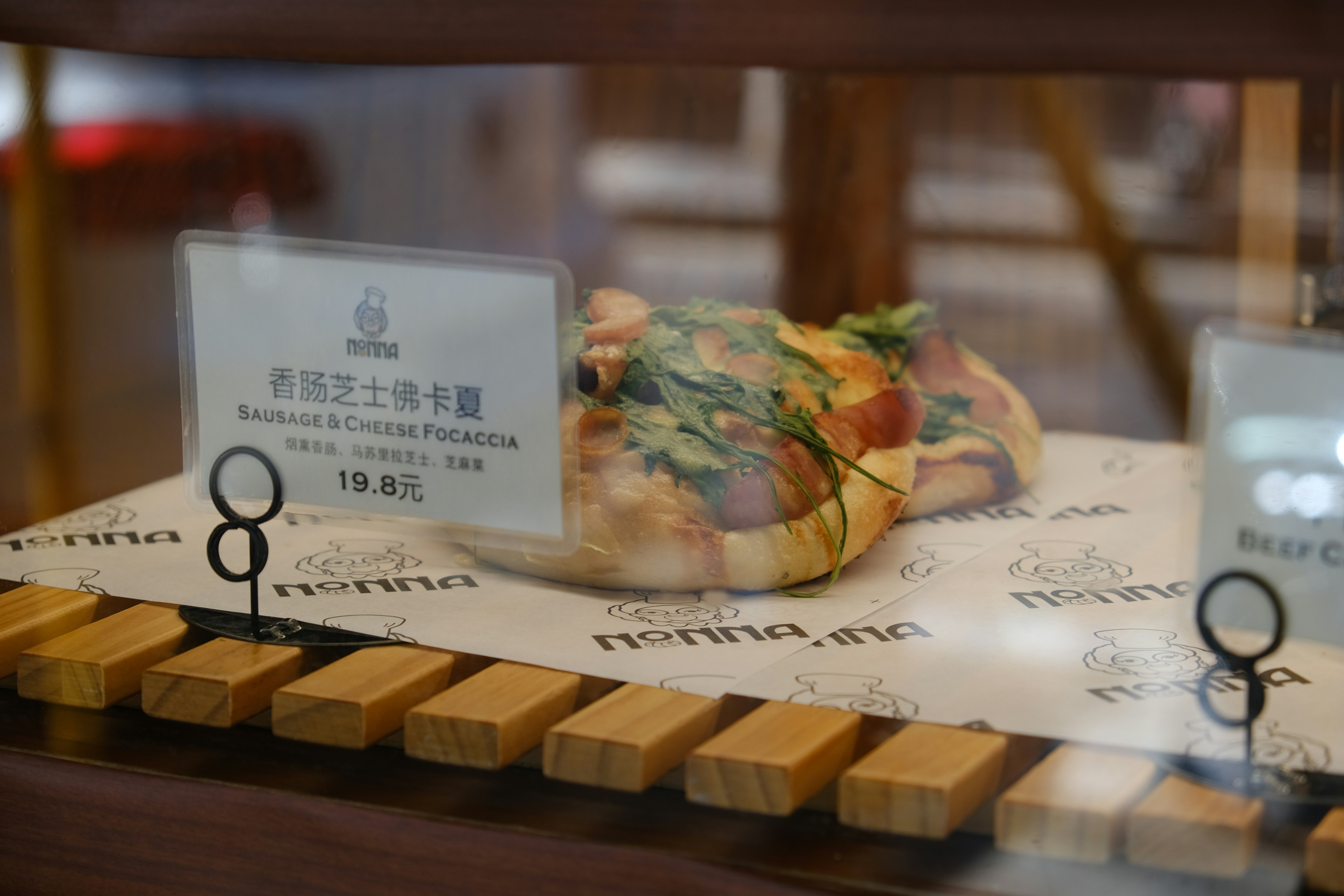 a close up of a pizza in a display case