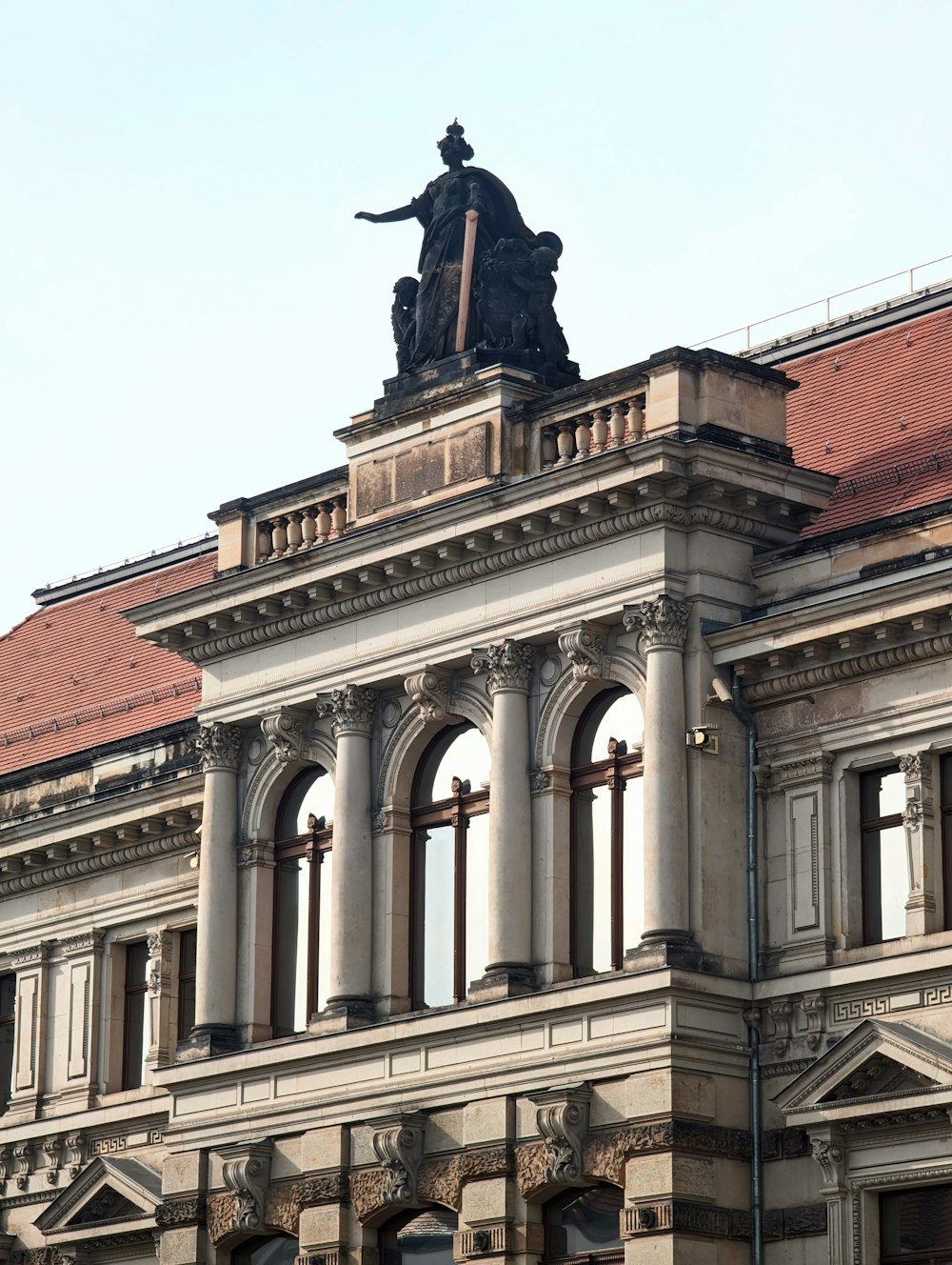 a large building with a statue on top of it