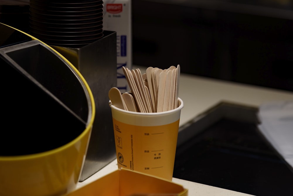 a yellow cup sitting on top of a counter