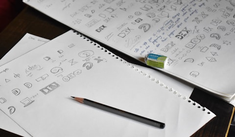 a pencil sitting on top of a pile of paper