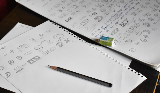 a pencil sitting on top of a pile of paper