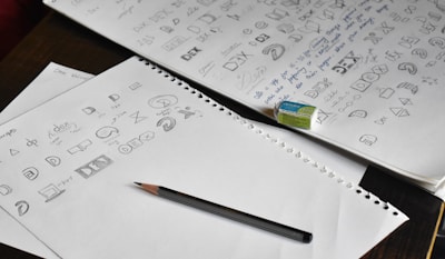 a pencil sitting on top of a pile of paper