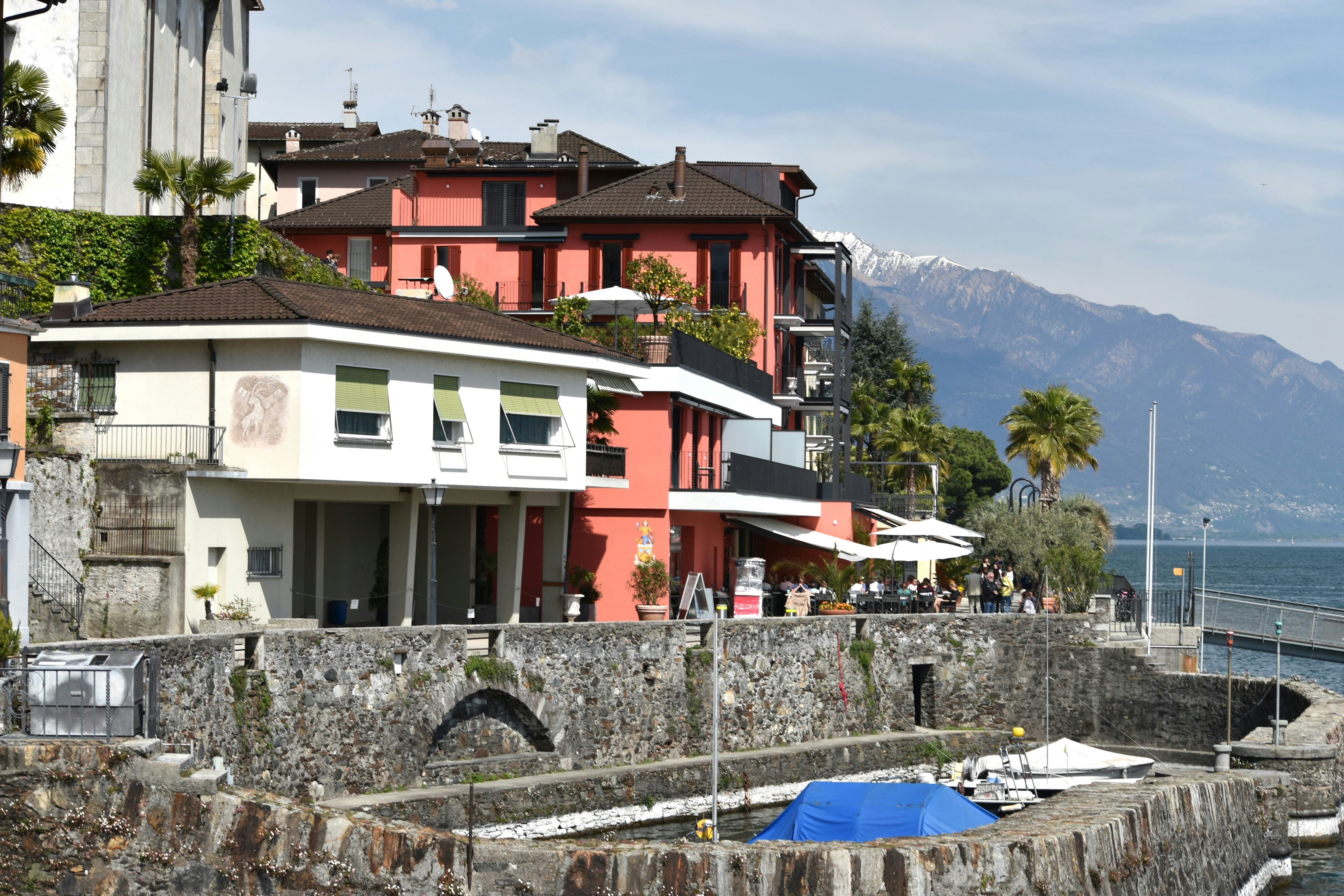 a row of houses next to a body of water, Brissago, Switzerland