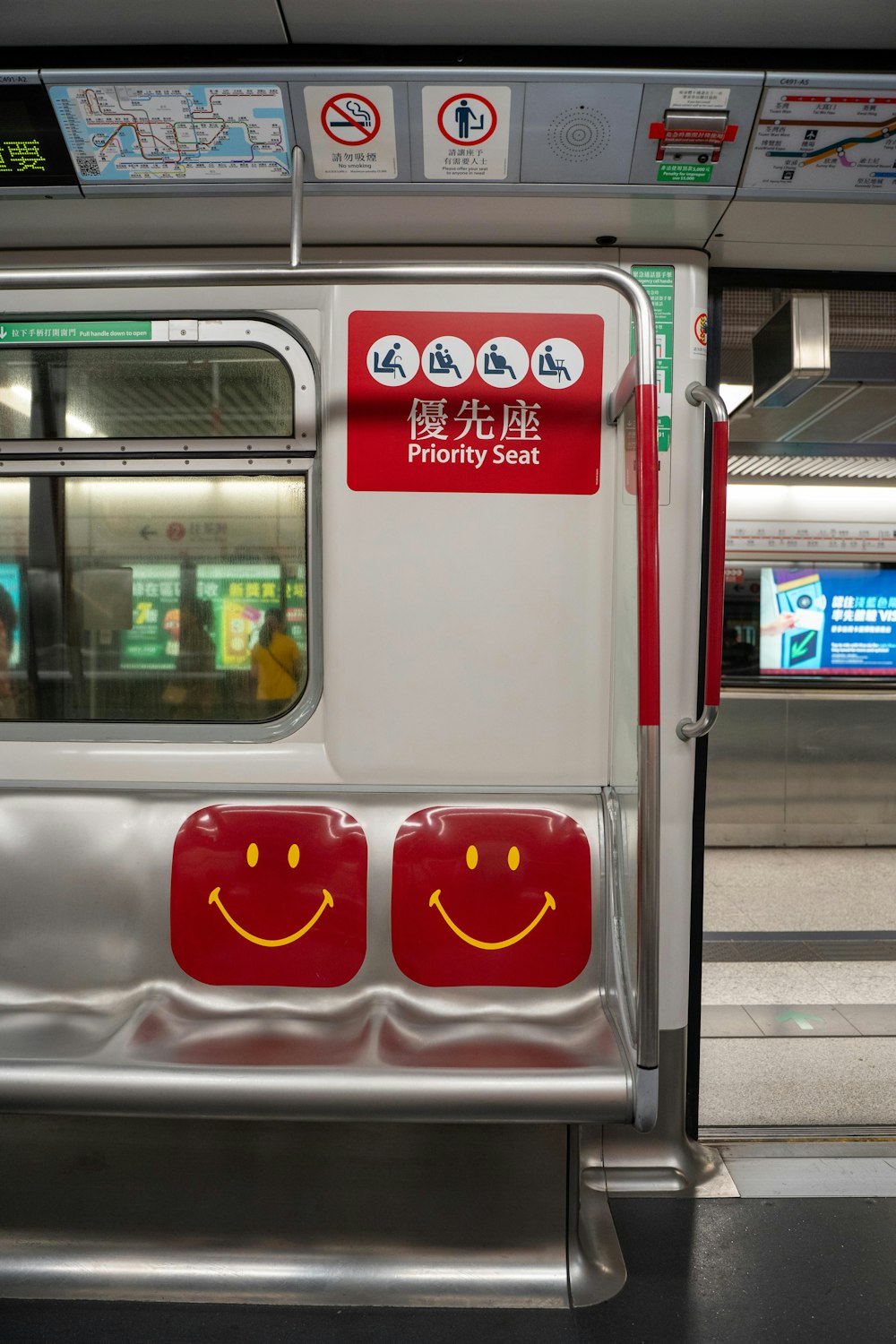 a subway car with a smiley face painted on the side