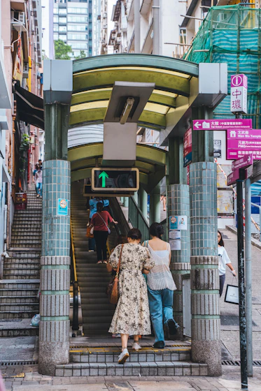 a group of people standing at the top of a set of stairs