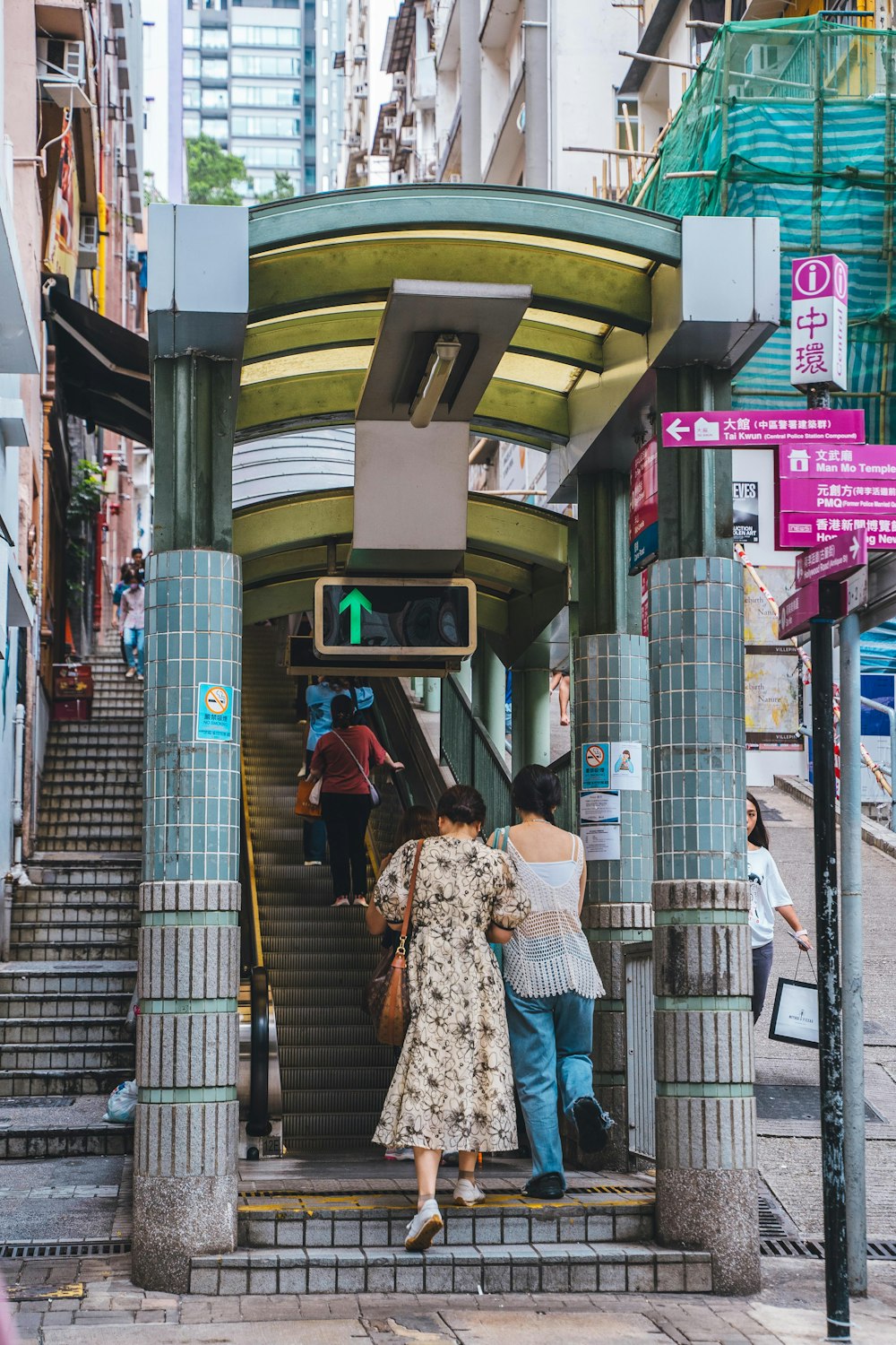 a group of people standing at the top of a set of stairs