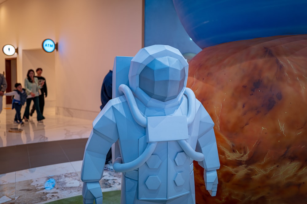 a man in a space suit standing in front of a painting