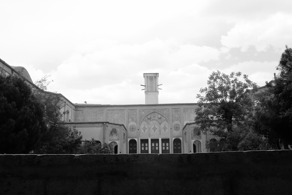 a black and white photo of a building with a clock tower