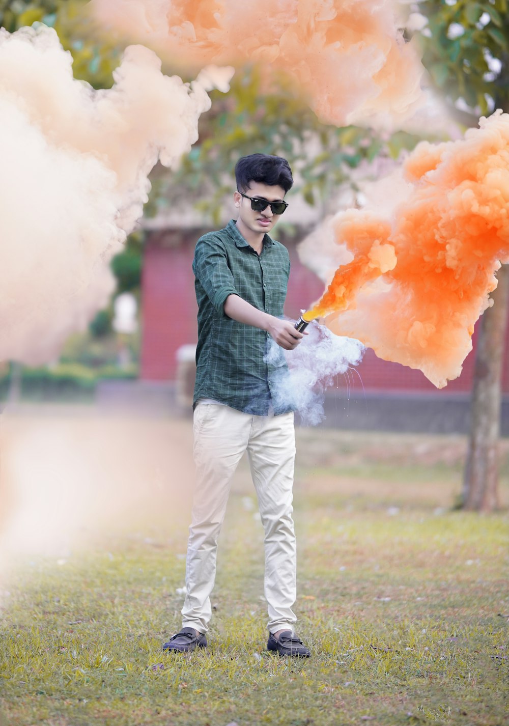 a man holding a fire extinguisher in a park