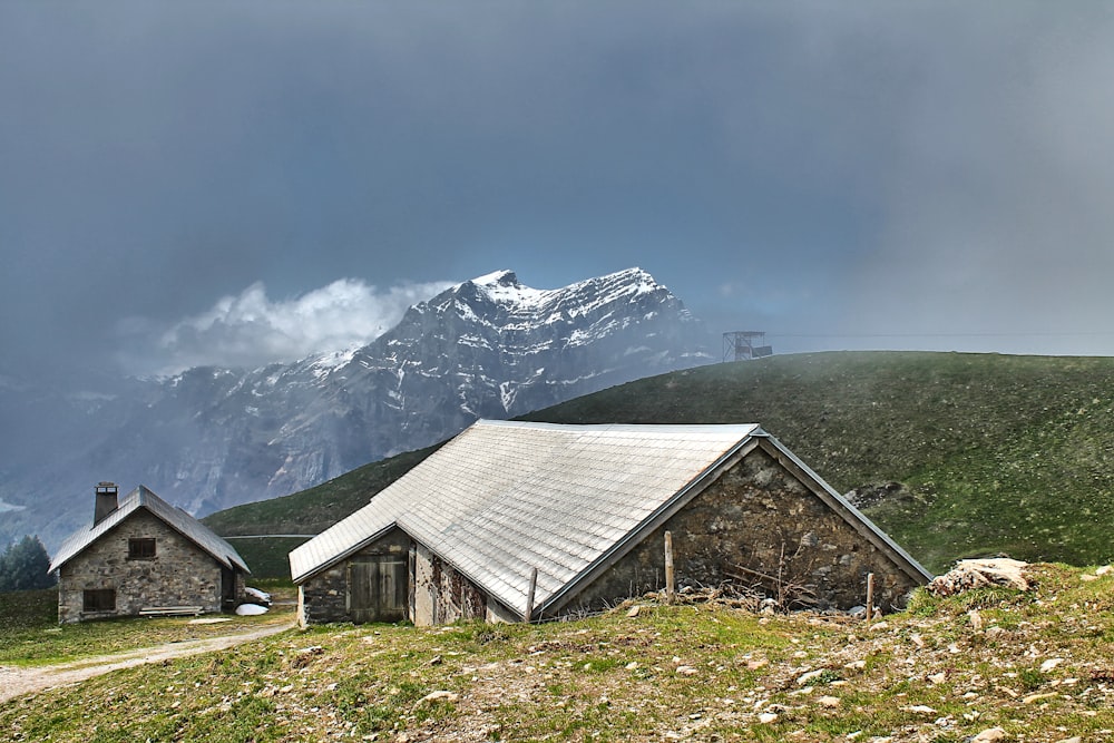 a couple of buildings sitting on top of a lush green hillside