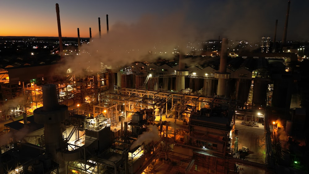 a factory with smoke coming out of it at night