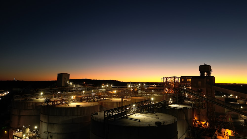 a factory with a lot of tanks at night