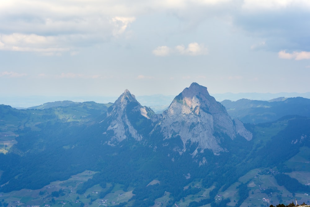 a view of a mountain range from the top of a hill