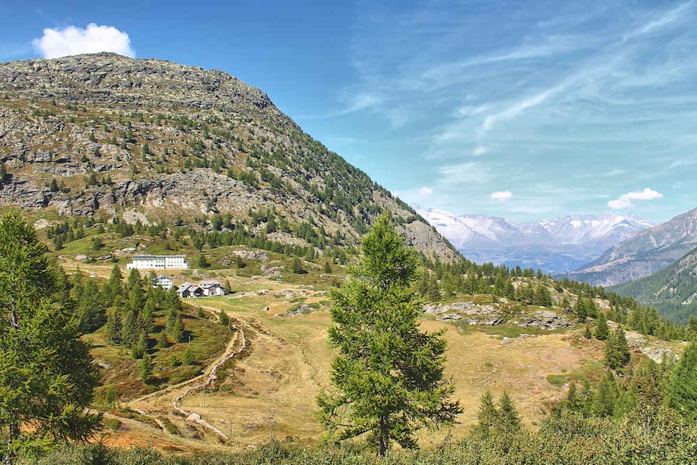 a view of a mountain with a house in the distance