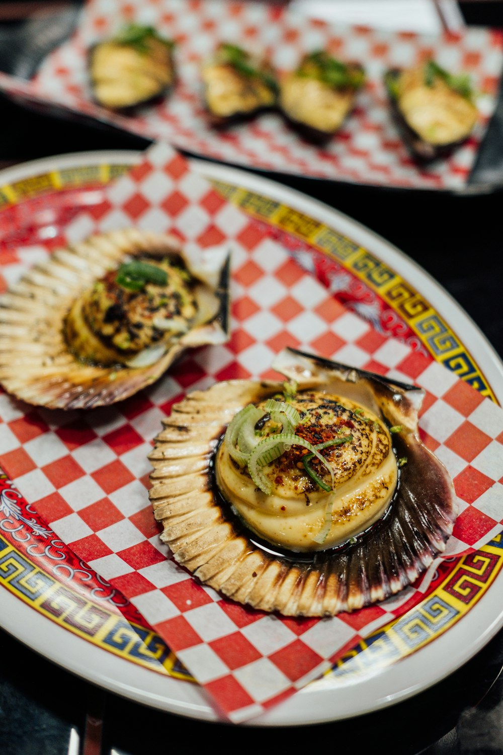 a plate of food on a red and white checkered table cloth