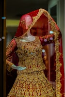 a mannequin dressed in a red and gold outfit