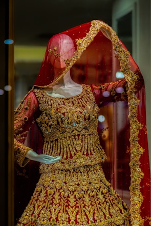 a mannequin dressed in a red and gold outfit