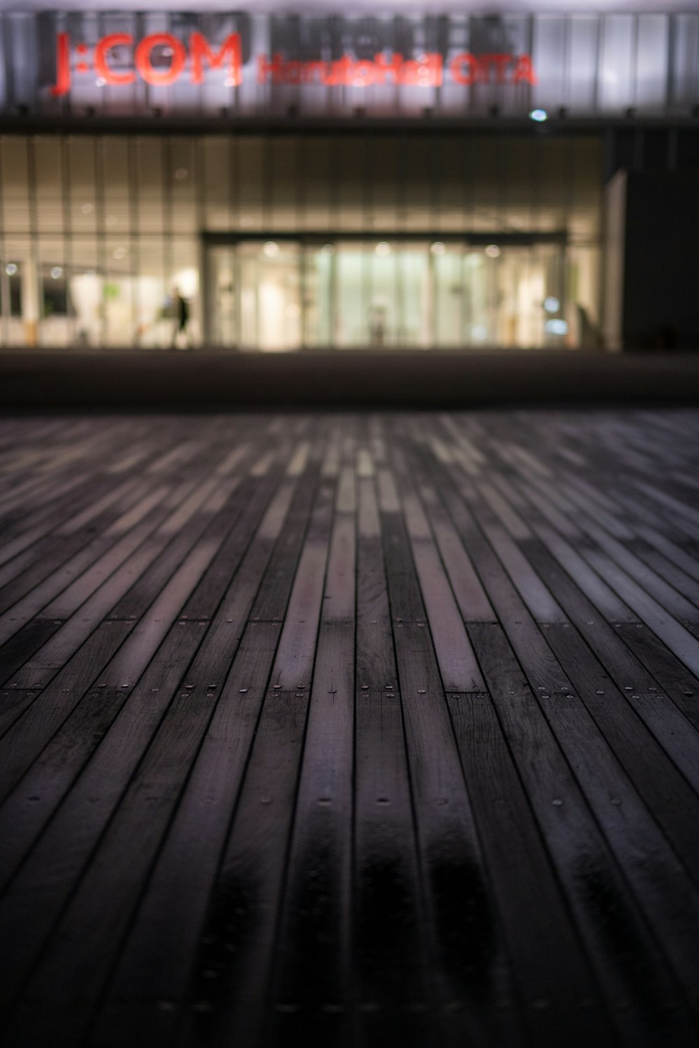 a wooden floor with a building in the background
