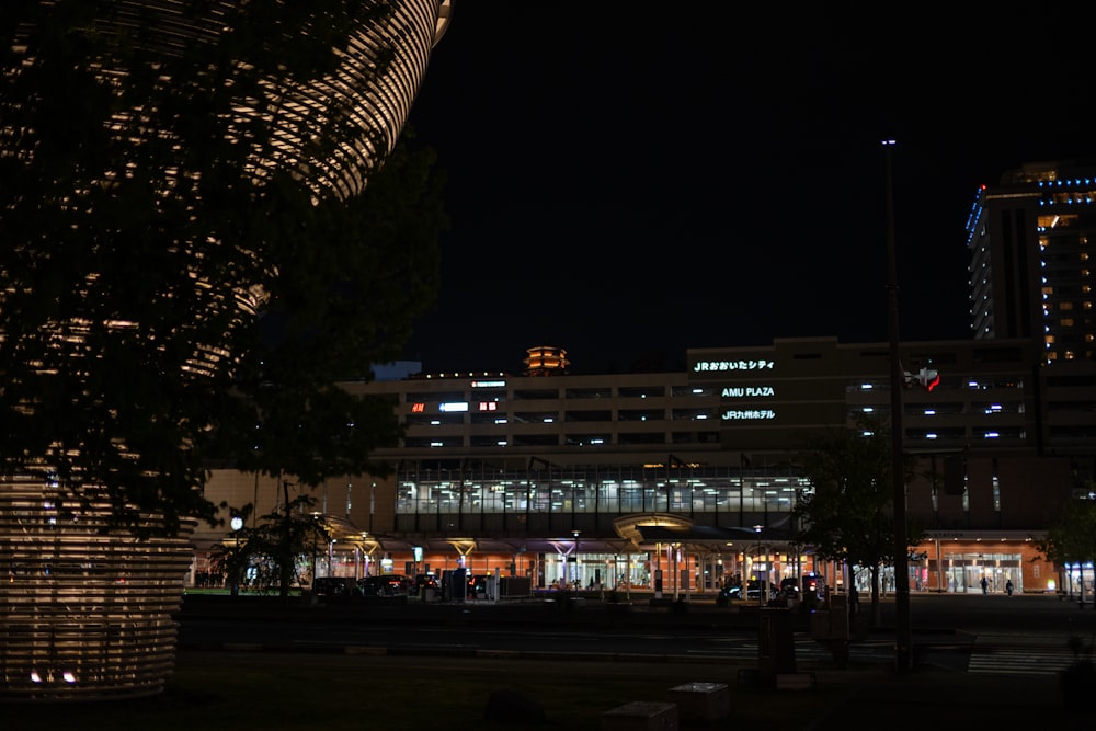 a building lit up at night in a city