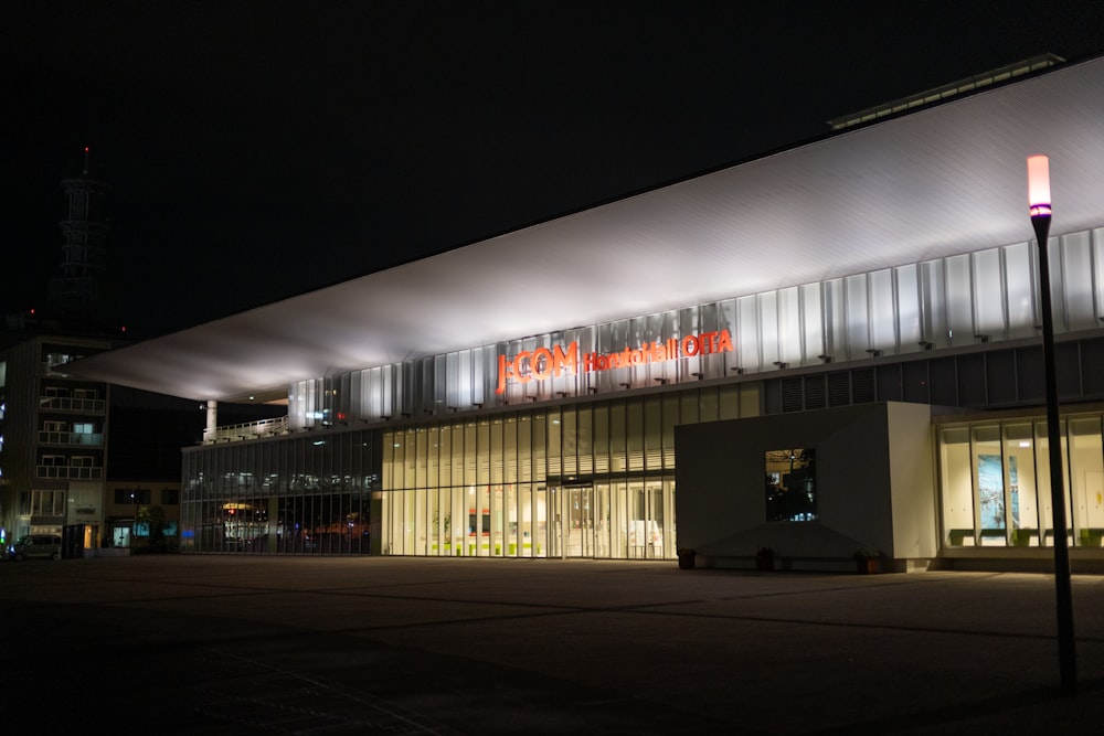 a large building with a lit up sign on it's side