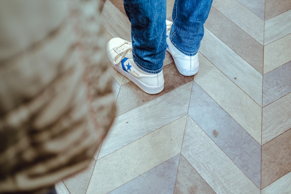 a person standing on top of a wooden floor