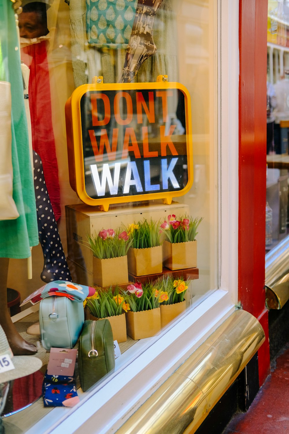 a store window with a sign that says don't walk walk