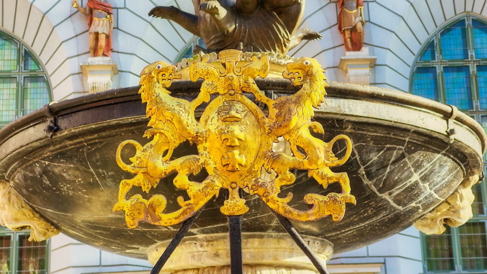 a statue of a bird on top of a fountain