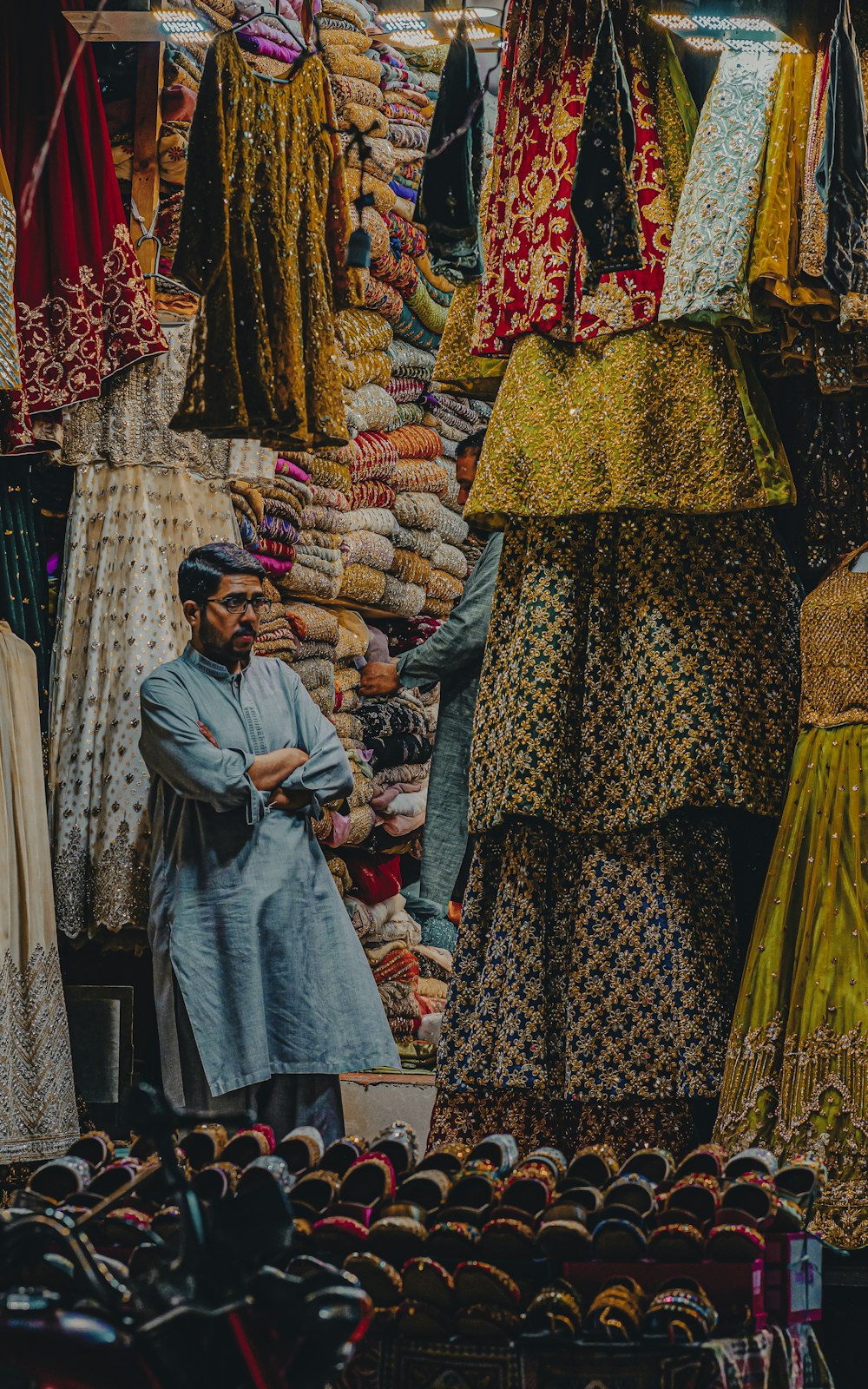 a man standing in front of a display of clothing