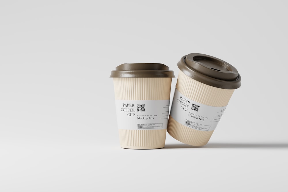 two coffee cups sitting next to each other