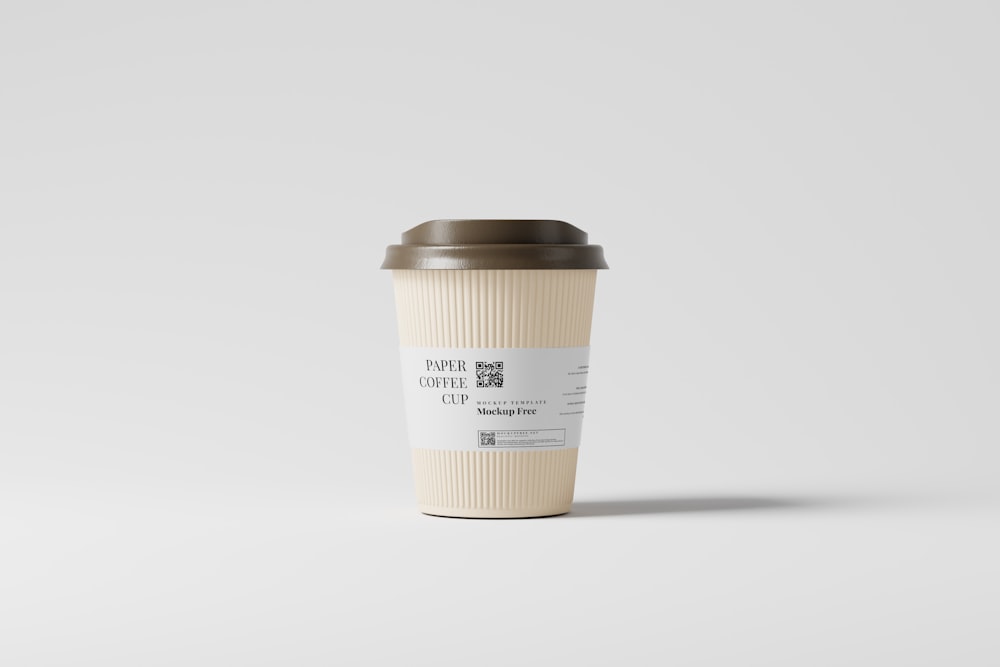 a coffee cup sitting on top of a white table