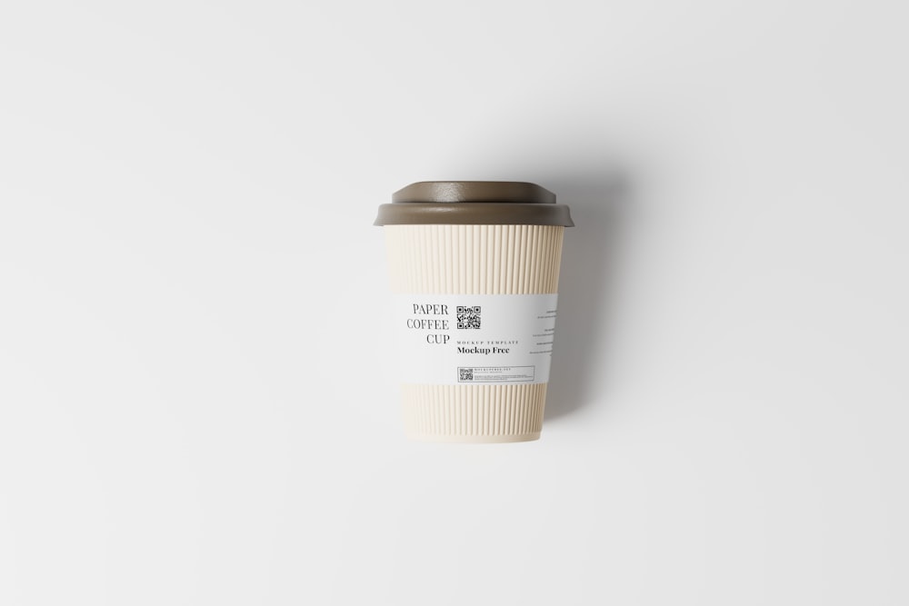 a coffee cup sitting on top of a white wall