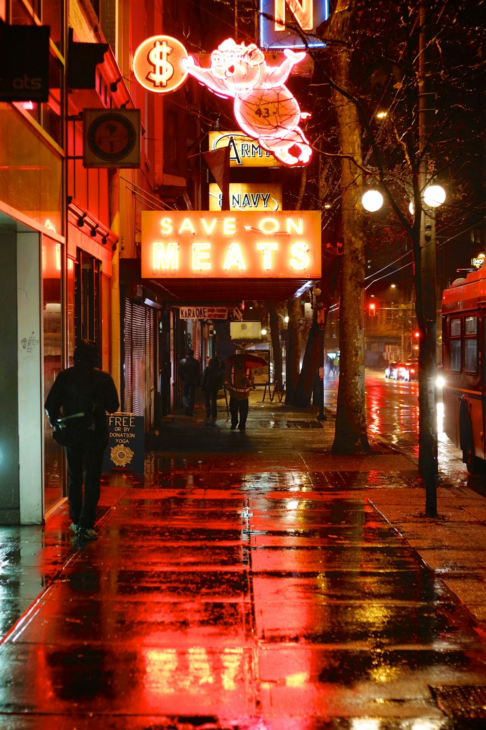 a person walking down a street at night