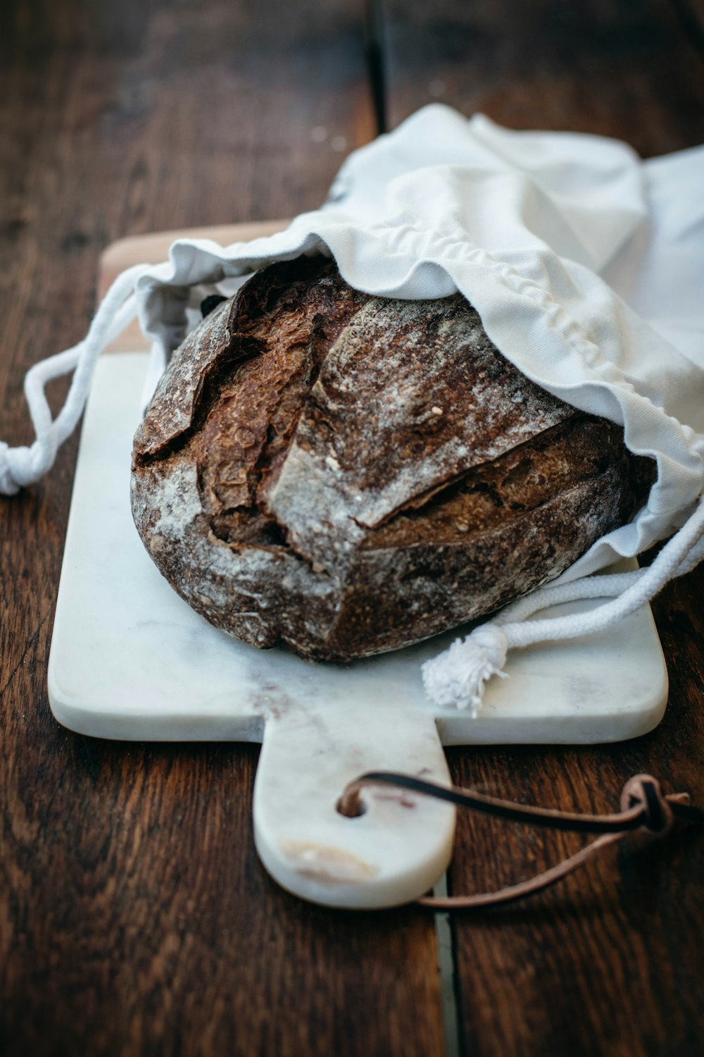 a loaf of bread sitting on top of a cutting board