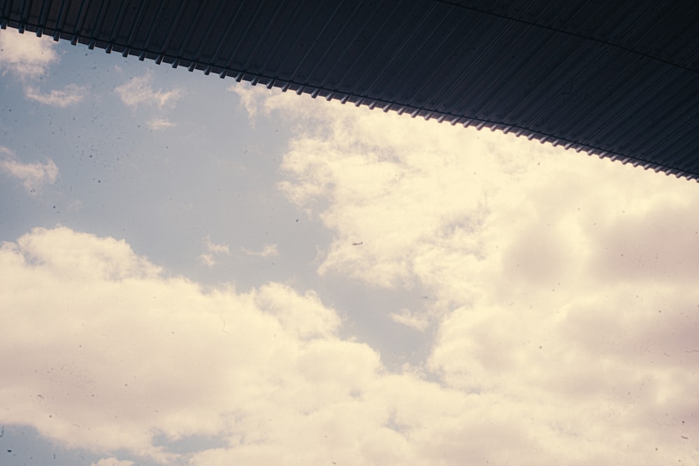 a view of the sky from underneath a building