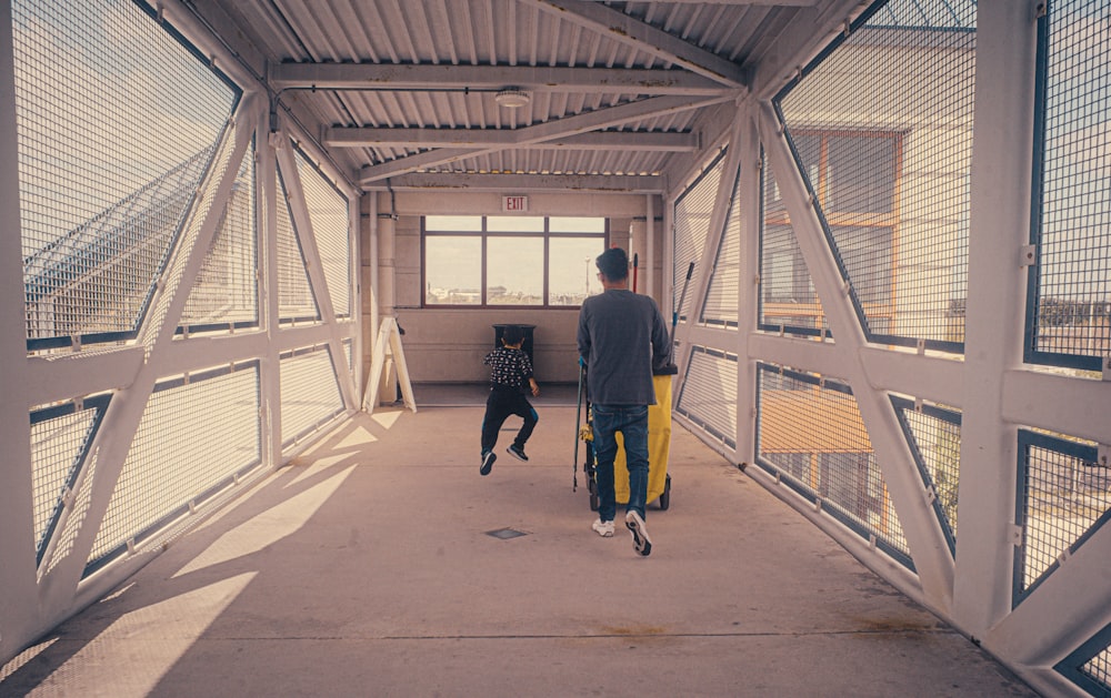 a couple of people that are walking down a walkway