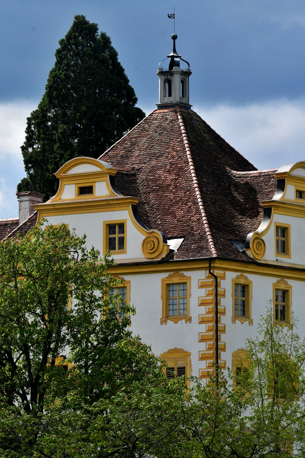 a white and yellow building with a clock tower