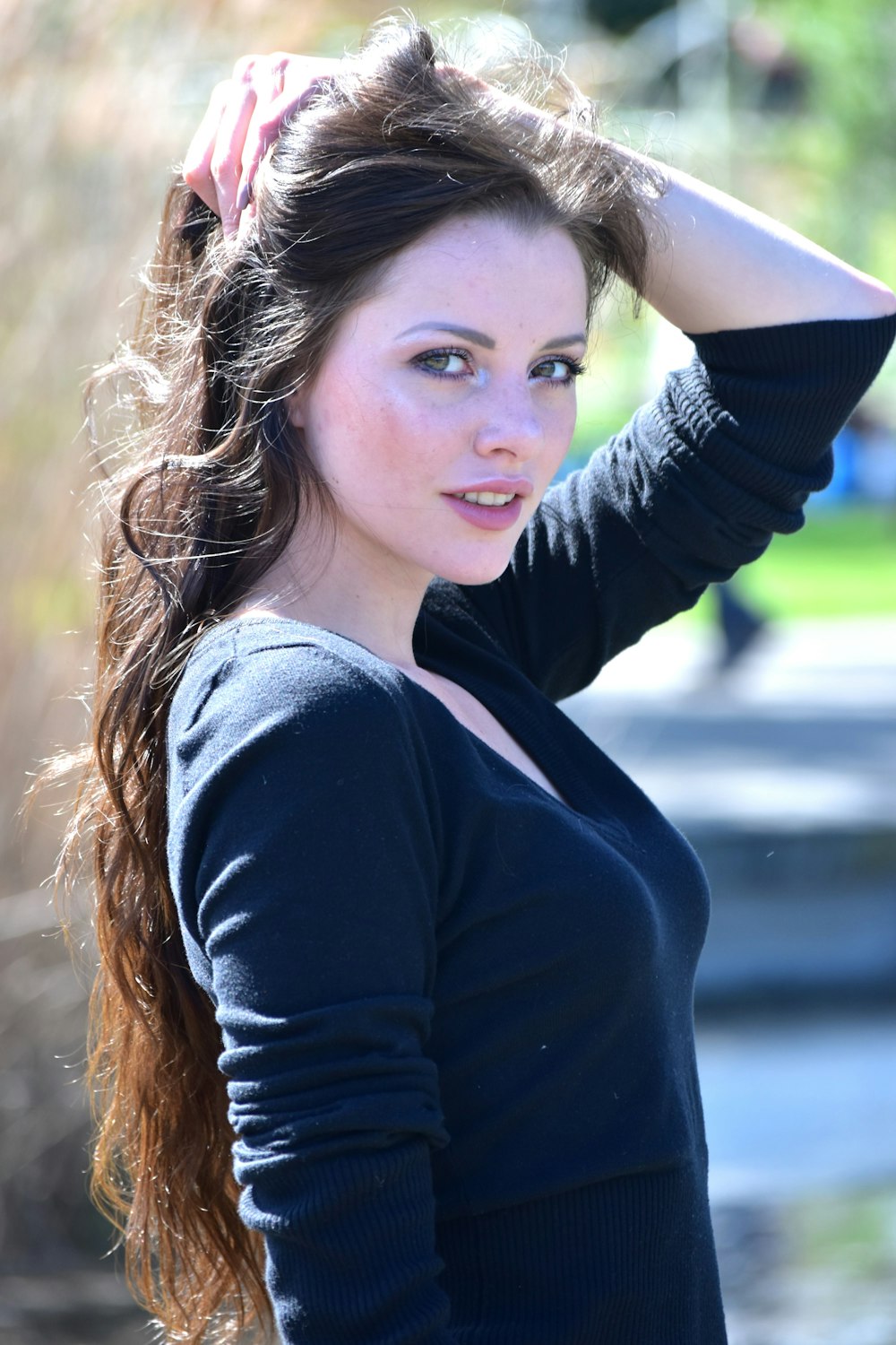 a woman with long hair is posing for a picture