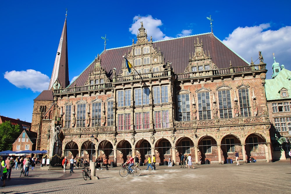 a large building with people walking around it