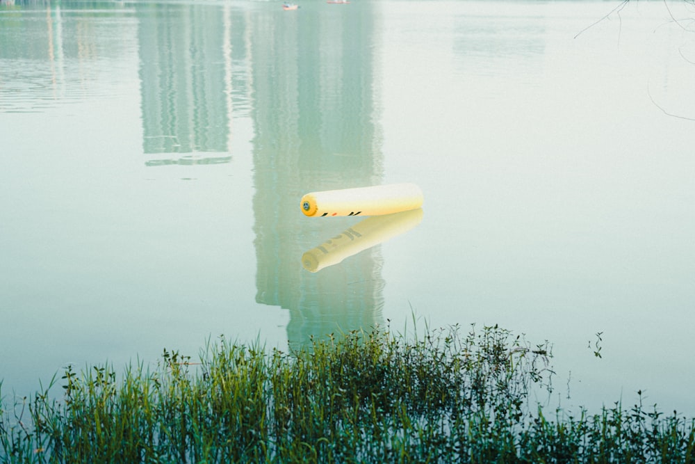 a yellow object floating on top of a body of water