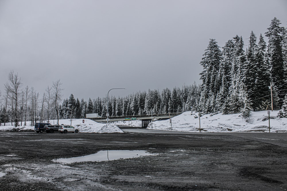 a truck driving down a snow covered road