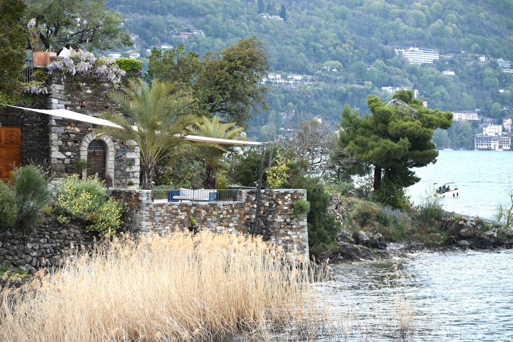 a stone building next to a body of water